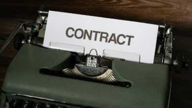 a close up of a typewriter with a sign that reads contact
