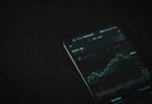 black android smartphone on black textile