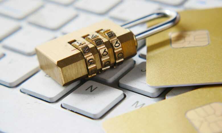 a golden padlock sitting on top of a keyboard