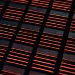 a close up of a metal grate with red lights