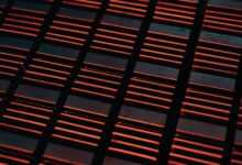 a close up of a metal grate with red lights