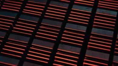 a close up of a metal grate with red lights