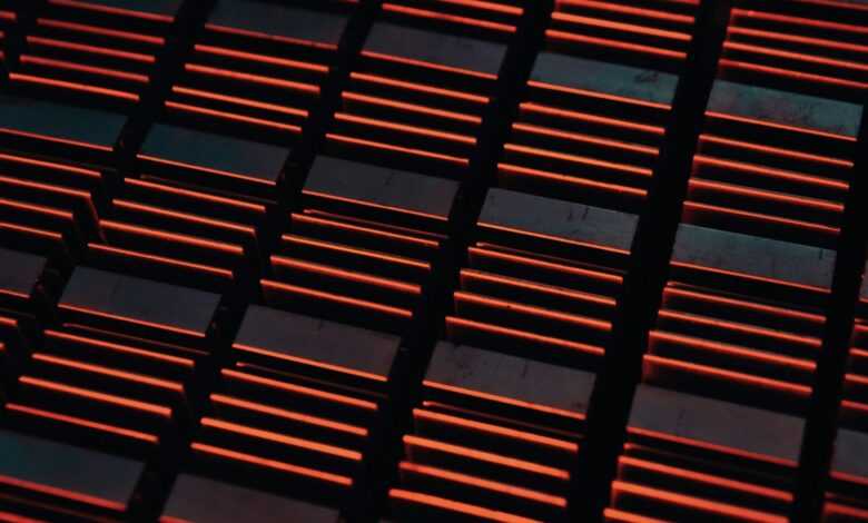 a close up of a metal grate with red lights