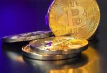 a pile of gold bitcoins sitting on top of a table