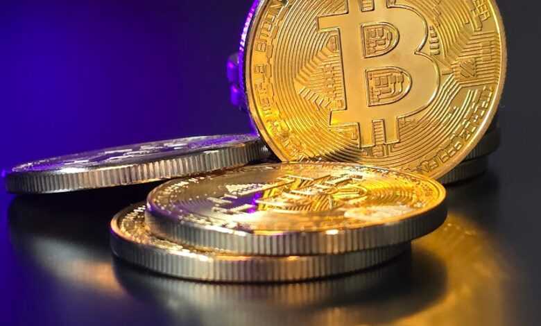 a pile of gold bitcoins sitting on top of a table